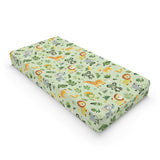 Jungle animal changing pad cover on a nursery changing table