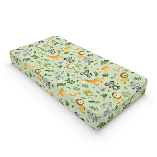 Jungle animal changing pad cover on a nursery changing table