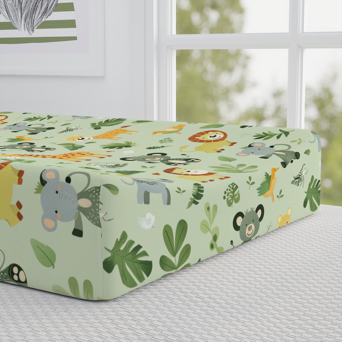 Close-up of the jungle print on a nursery changing pad cover