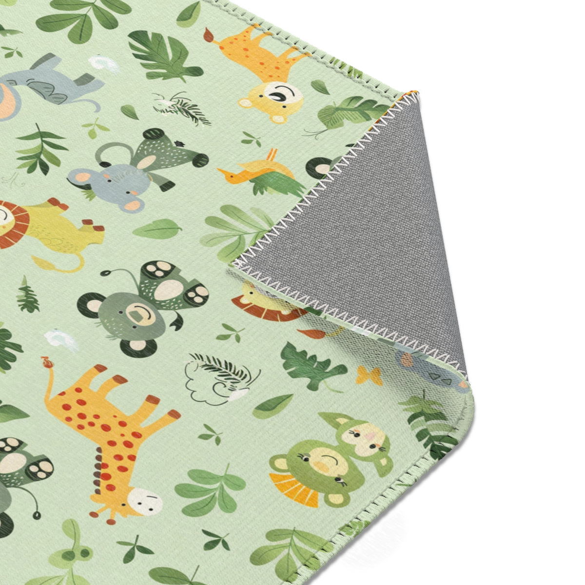 Jungle animal rug beside a nursery glider chair