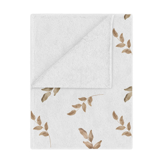 Linen Leaf minky baby blanket draped over a crib