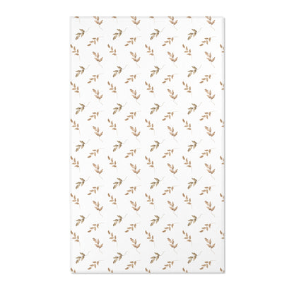 Neutral botanical nursery area rug in taupe and tan on white