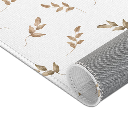 Watercolour leaf sprigs printed across the nursery area rug