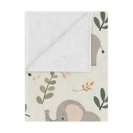 Little Elephants minky baby blanket draped over a crib
