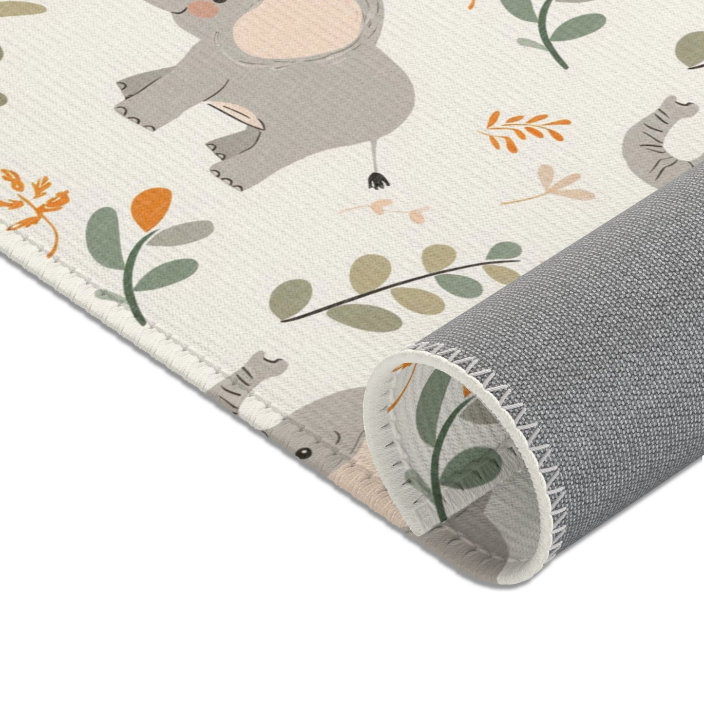 Elephants and leaf sprigs printed across the nursery area rug