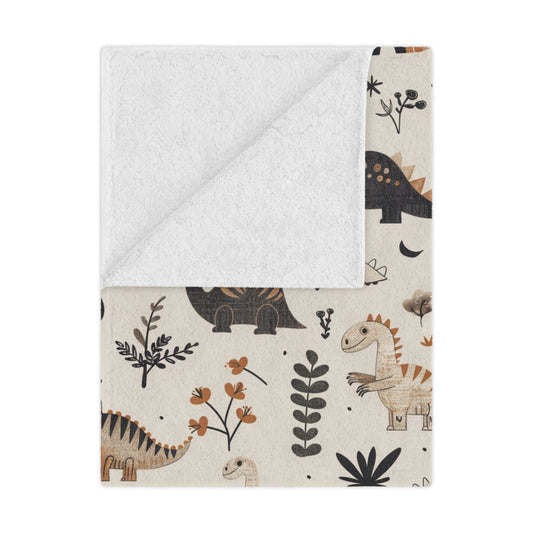 Meadow Dinosaurs minky baby blanket draped over a crib