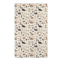 Dinosaur nursery area rug in charcoal, tan and ochre on cream