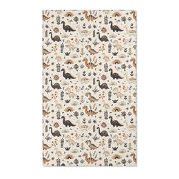 Dinosaur nursery area rug in charcoal, tan and ochre on cream