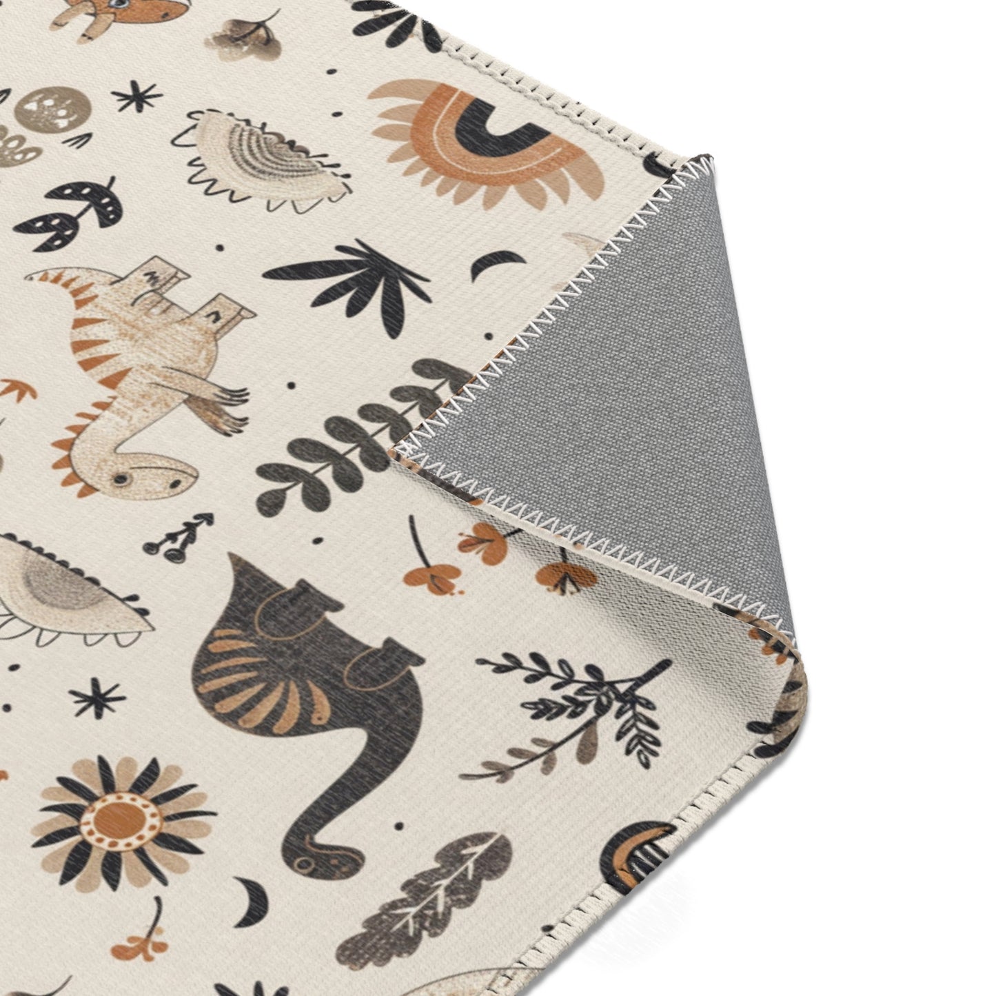 Dinosaur rug in charcoal and ochre for a nursery floor