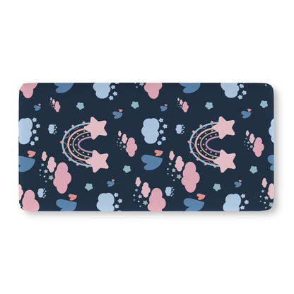 Fitted crib sheet with pastel rainbows and stars on deep navy