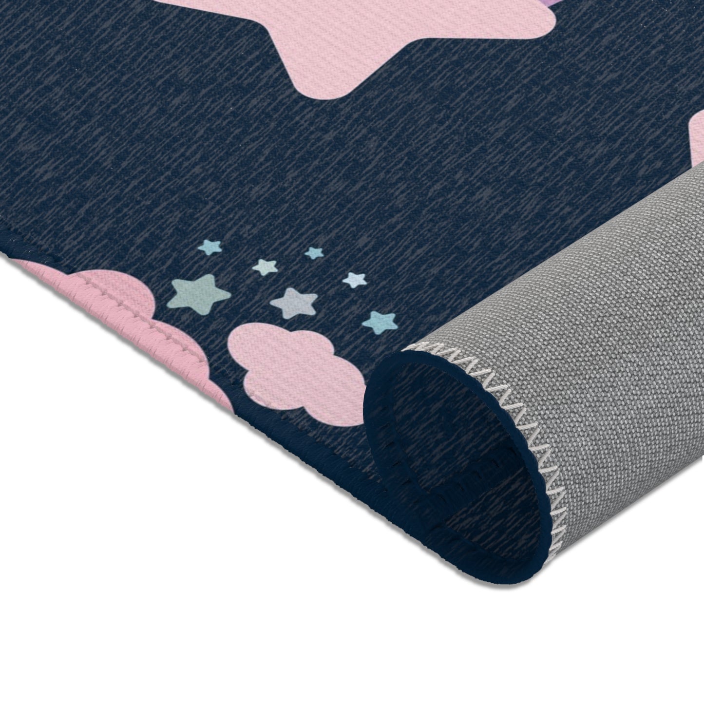 Rainbows, stars and clouds printed across the nursery area rug