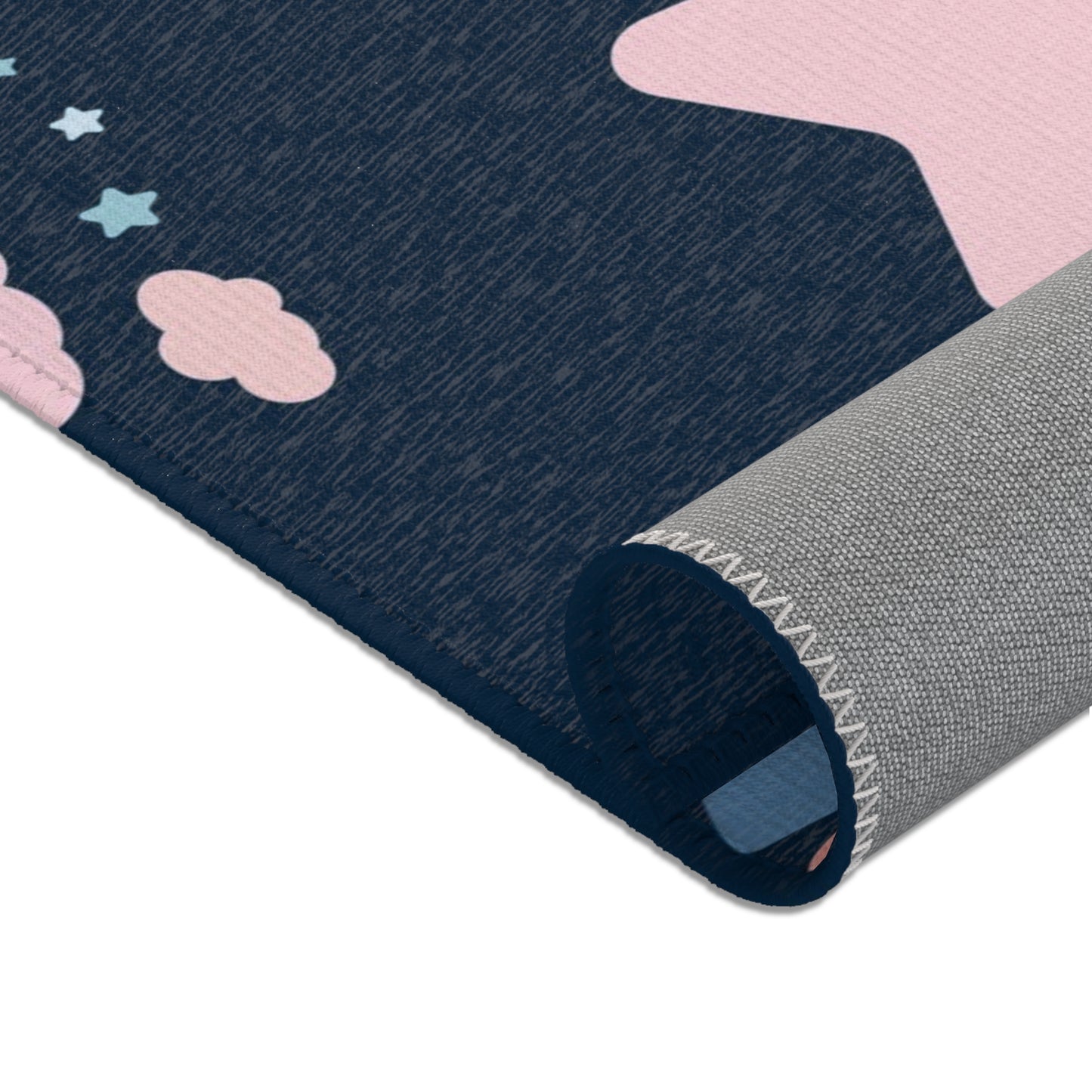 Nursery area rug in a navy, pink and pale blue palette