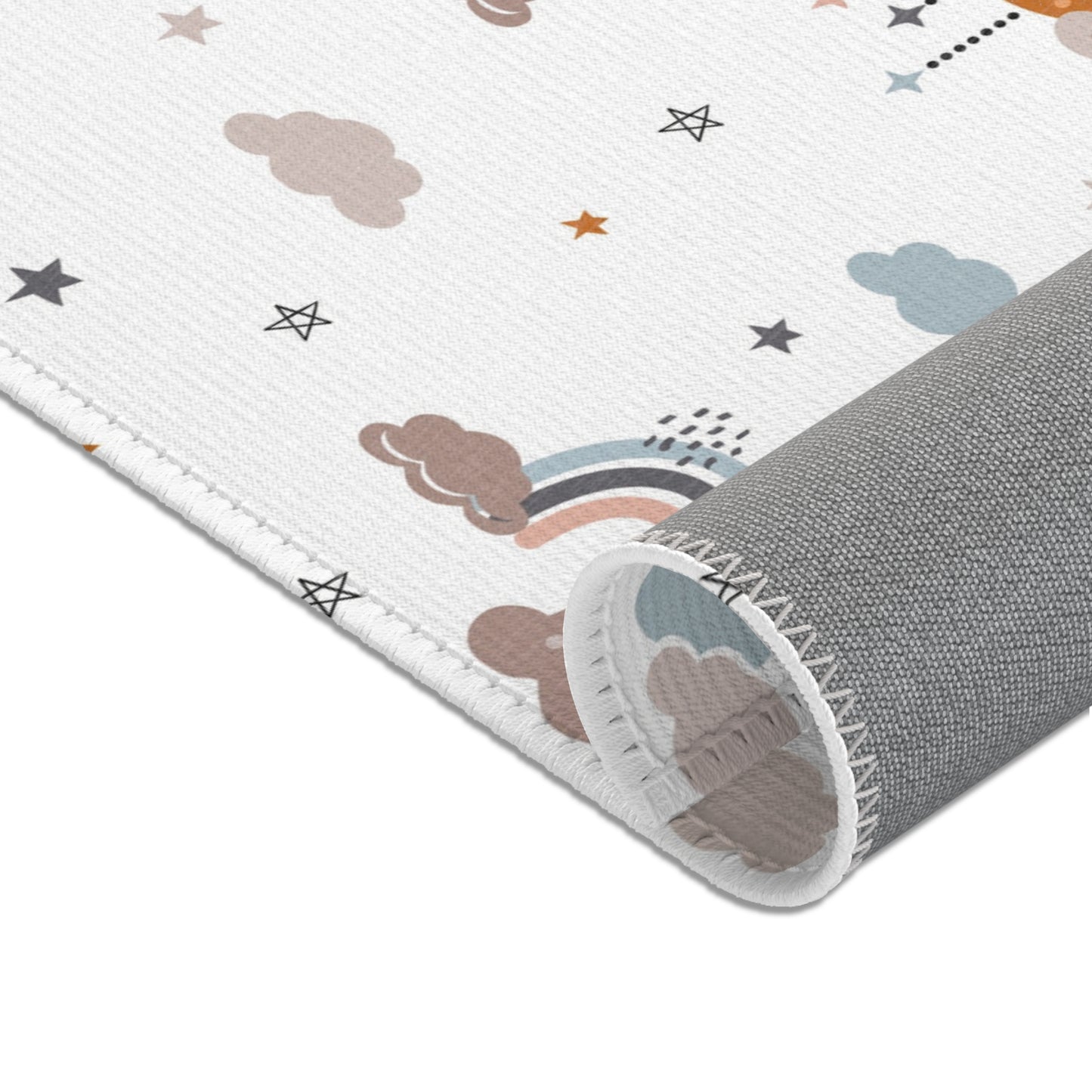 Nursery area rug in a soft ochre, grey and white palette