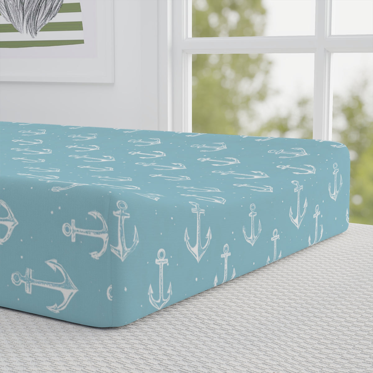 Close-up of the anchor print on a nursery changing pad cover