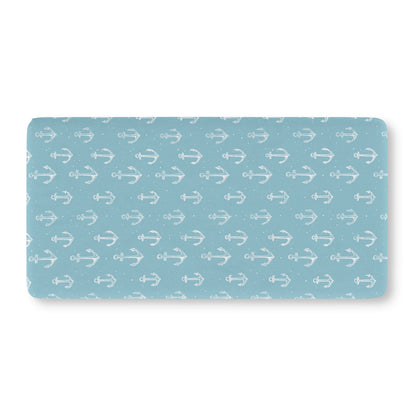 Teal anchor crib sheet showing the fitted elasticated corner