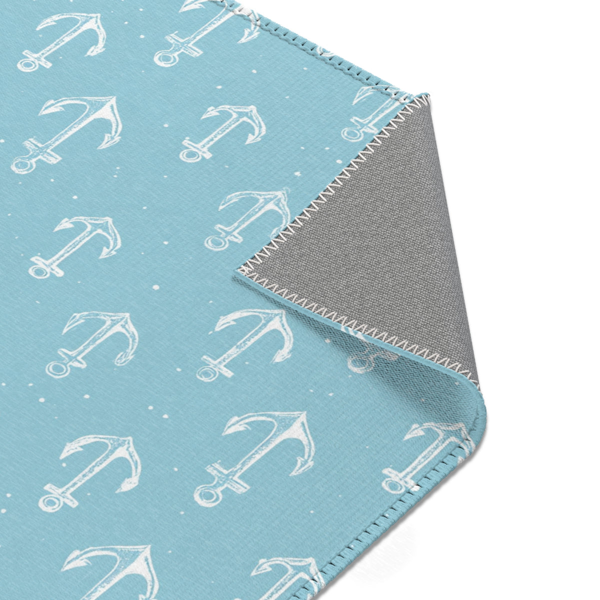 Nautical anchor area rug styled with nursery furniture