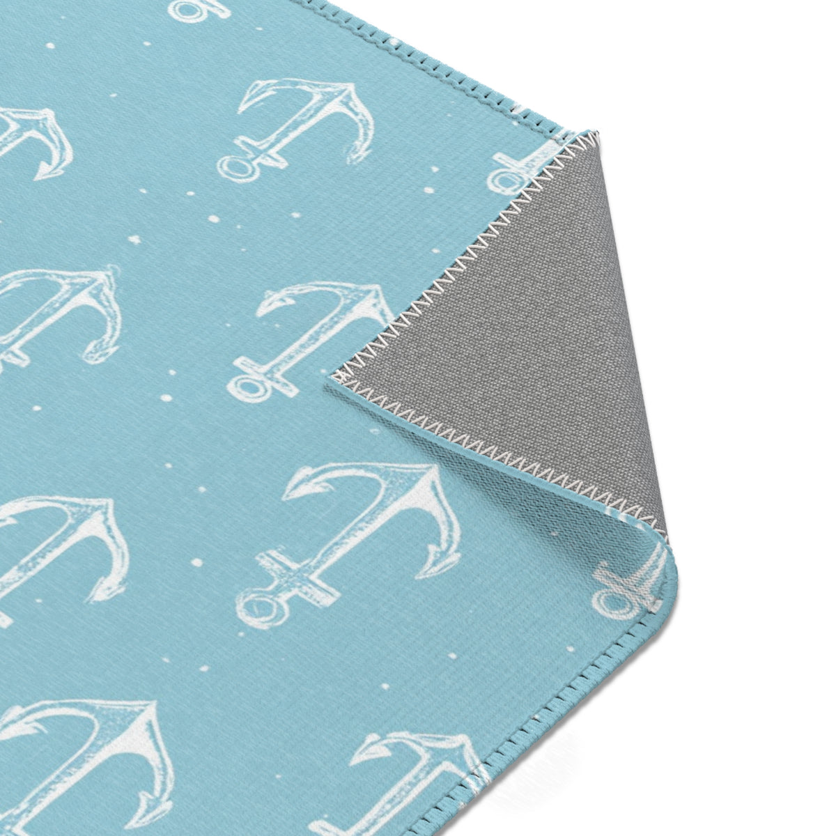Nautical anchor rug beside a nursery glider chair