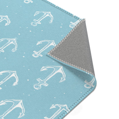 Nautical anchor rug beside a nursery glider chair