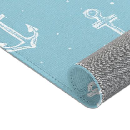 Teal anchor area rug in a baby nursery corner