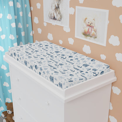 Nautical changing pad cover styled in a baby boy nursery