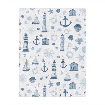 Nautical minky baby blanket draped over a crib
