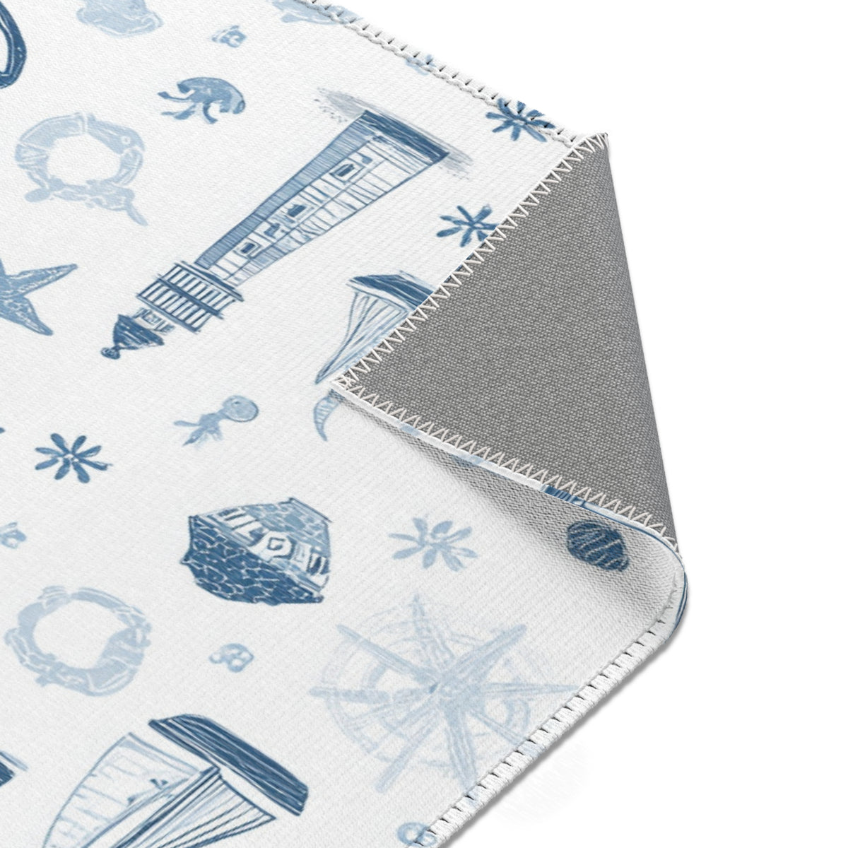 Nautical rug beside a nursery glider chair