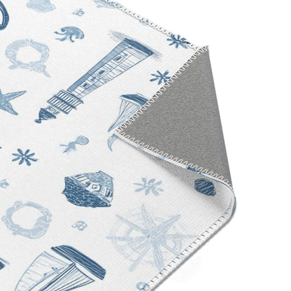 Nautical rug beside a nursery glider chair
