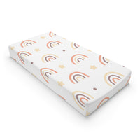 Peach Rainbow changing pad cover on a nursery changing table