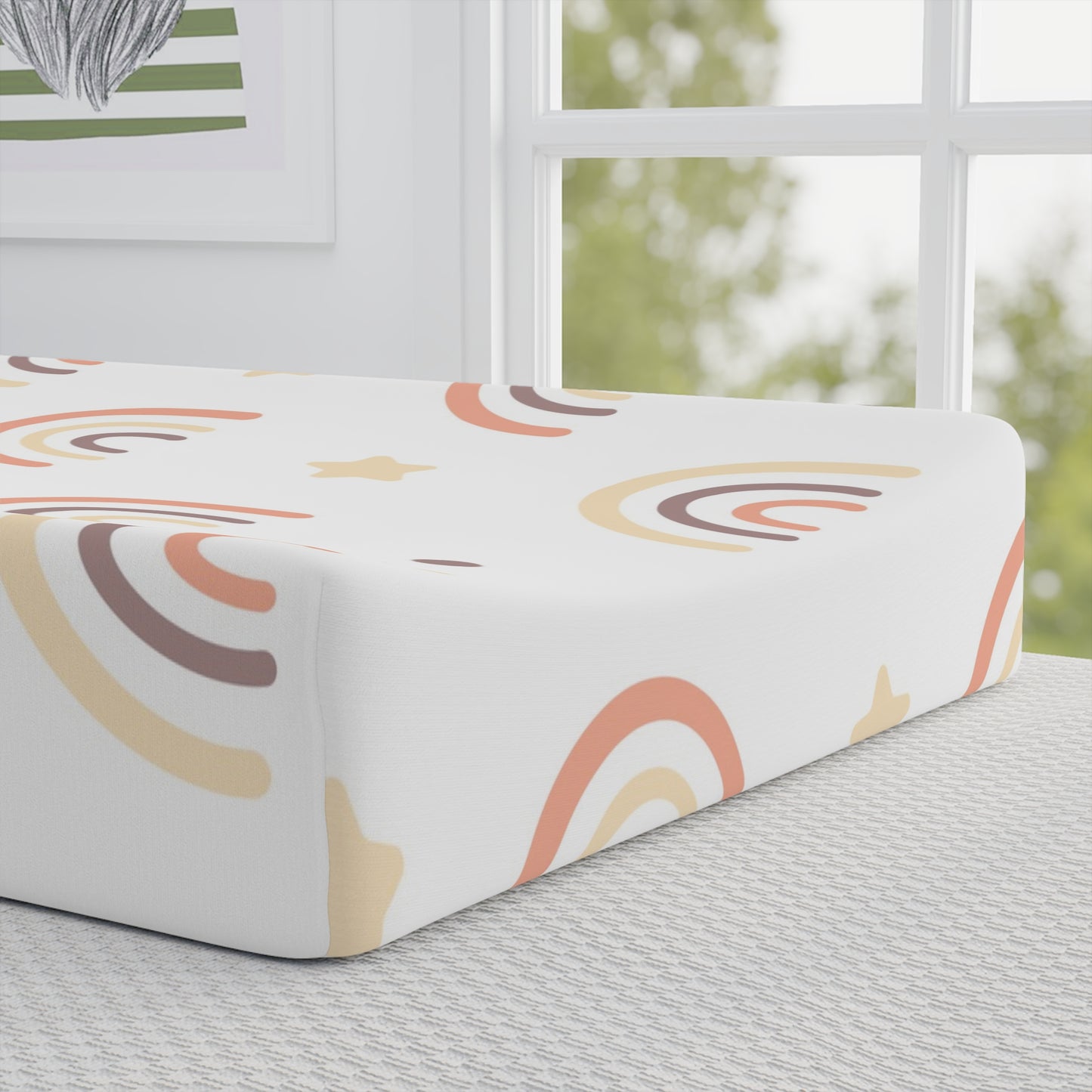 Close detail of the Peach Rainbow print on the changing pad cover