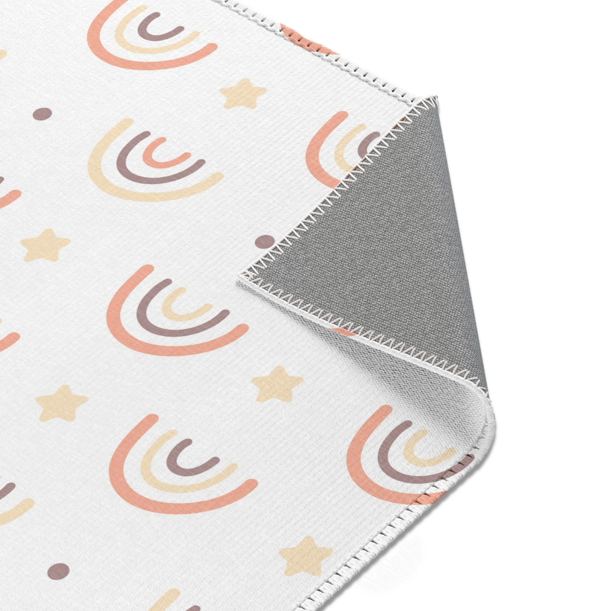 Nursery area rug printed edge to edge with drawn rainbows