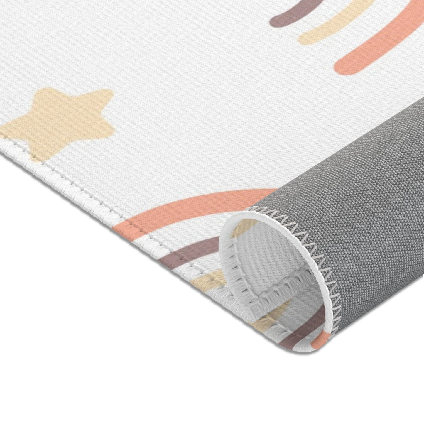 Nursery area rug in a soft peach, cream and taupe palette