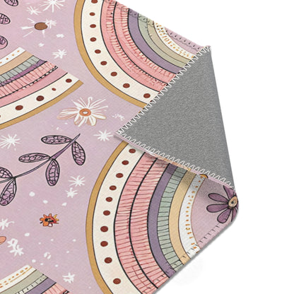 Blush arch rug in mauve and sage for a nursery floor