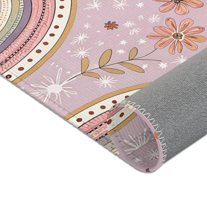 Rows of arches and small daisies across the nursery area rug