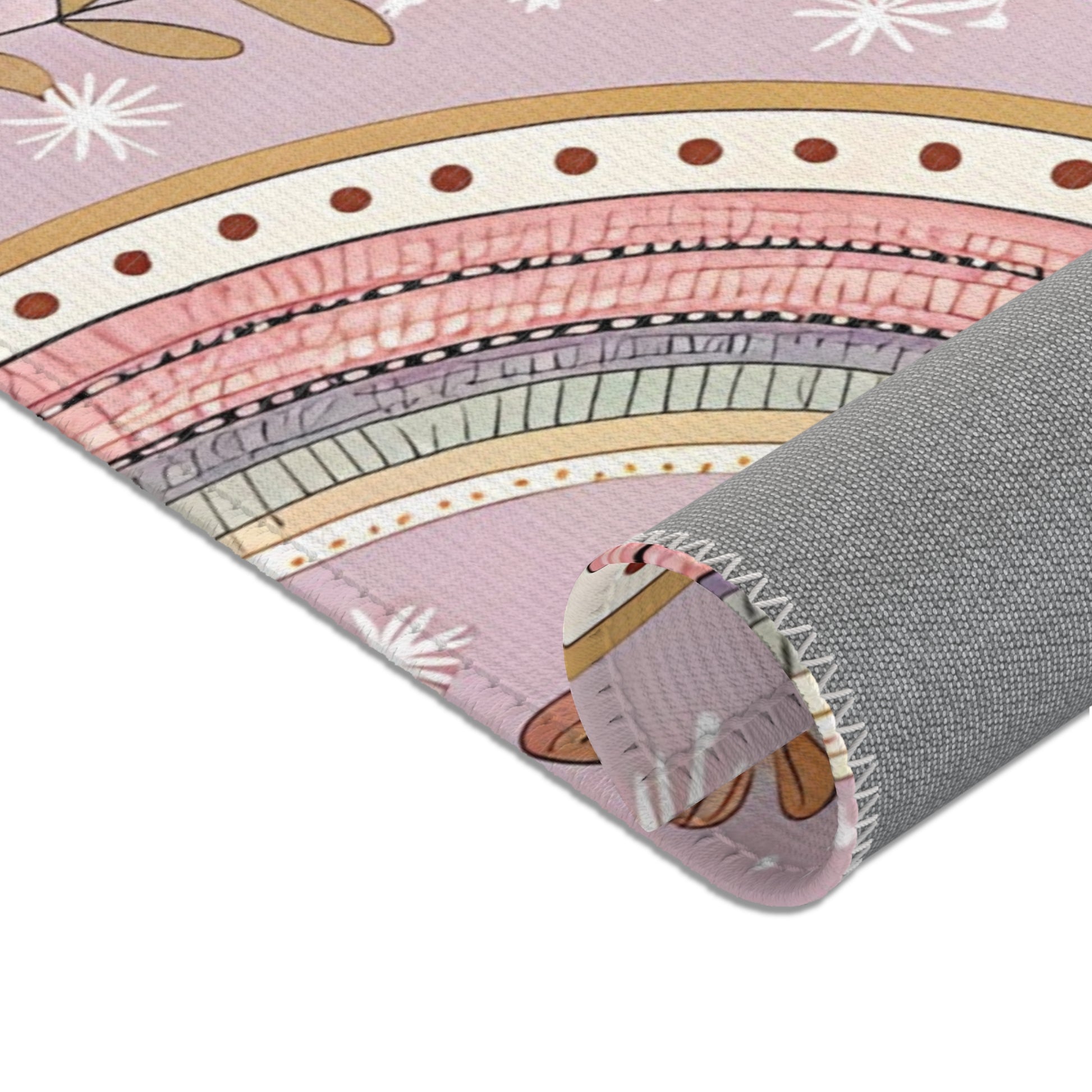 Nursery area rug in a blush, mauve and sage palette