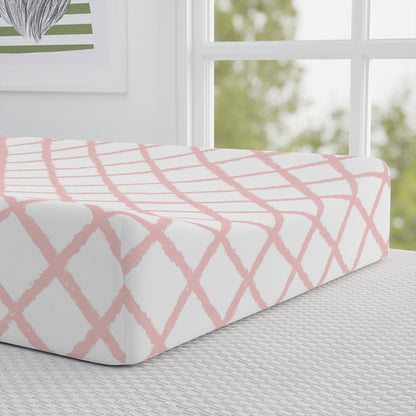 Close-up of the pink trellis print on a changing pad cover
