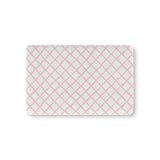 Pink trellis fitted crib sheet on a nursery crib mattress