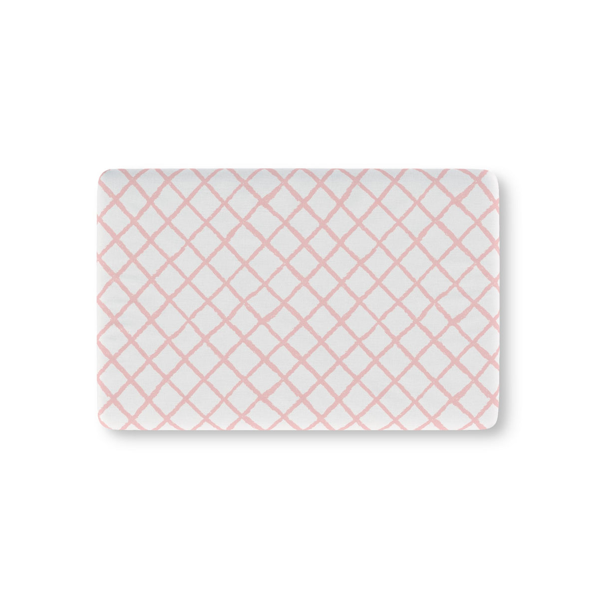 Pink trellis fitted crib sheet on a nursery crib mattress