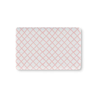 Pink trellis fitted crib sheet on a nursery crib mattress