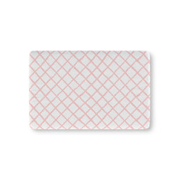Pink trellis fitted crib sheet on a nursery crib mattress