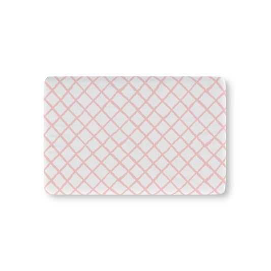 Pink trellis fitted crib sheet on a nursery crib mattress