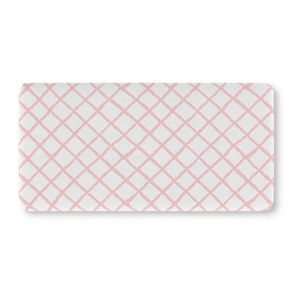 Soft pink lattice crib sheet showing the fitted elasticated corner
