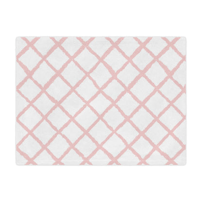 Close-up of the plush minky texture on a pink trellis baby blanket