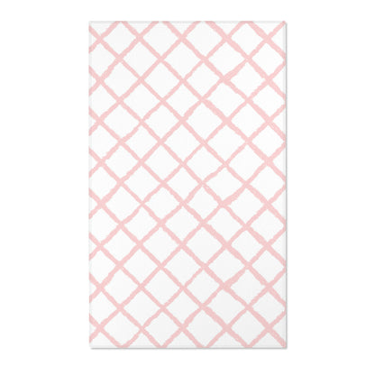 Rectangular pink lattice print nursery rug shown from above