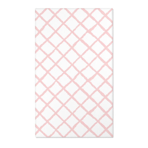 Rectangular pink lattice print nursery rug shown from above