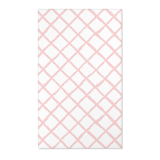 Rectangular pink lattice print nursery rug shown from above