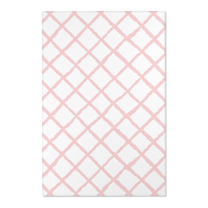 Close-up of the hand-painted pink trellis print on a nursery rug