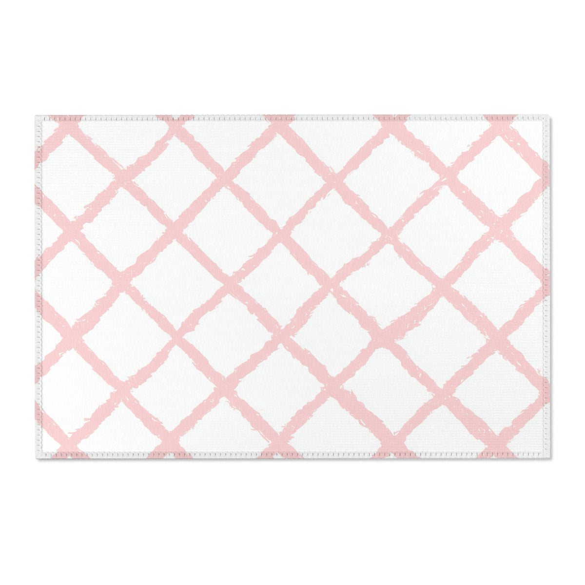 Washable pink trellis area rug under a nursery crib