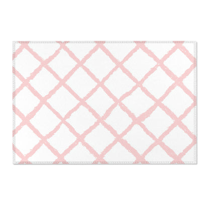 Washable pink trellis area rug under a nursery crib
