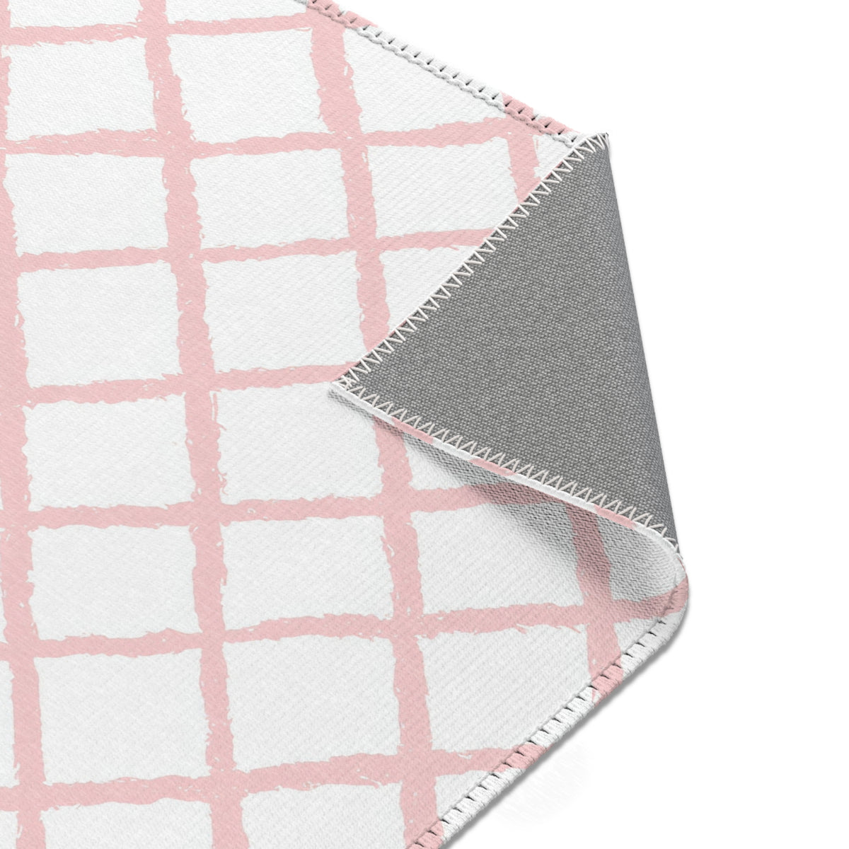 Pink trellis area rug styled with nursery furniture