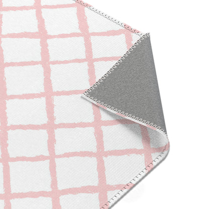 Pink trellis area rug styled with nursery furniture